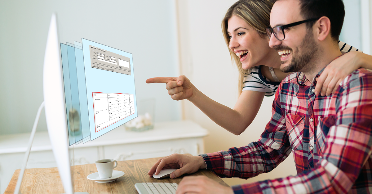 A man and woman smile and point at a computer screen as the tables in it come to life in 3D